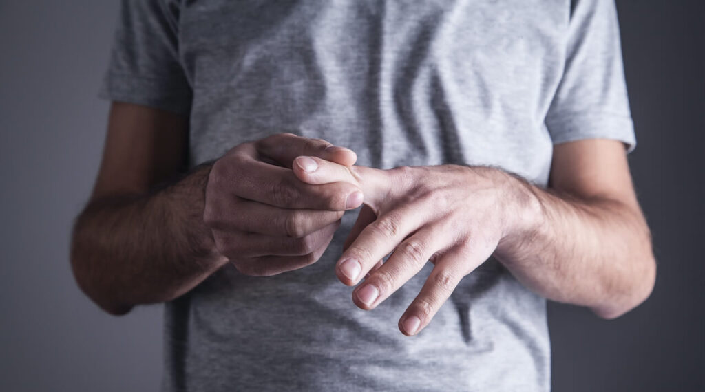 Caucasian man with finger ache. Arthritis, wrist pain